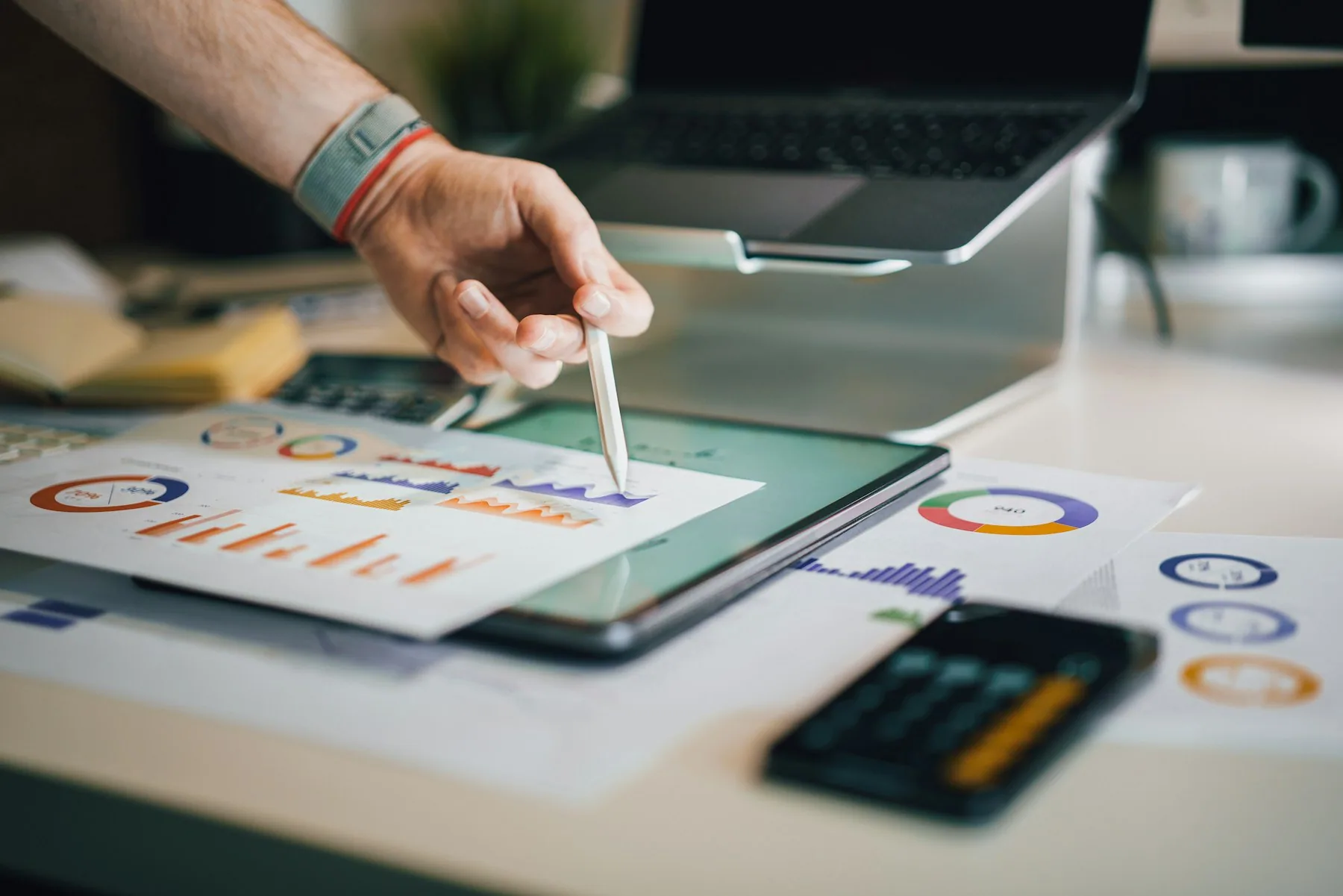 Business performance charts being analysed on a tablet